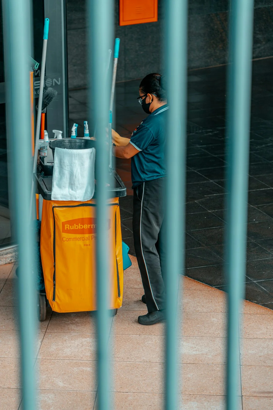 Two workers hanging to clean windows on a modern skyscraper facade.